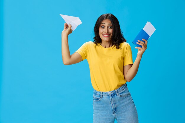 Young woman using mobile phone against blue background