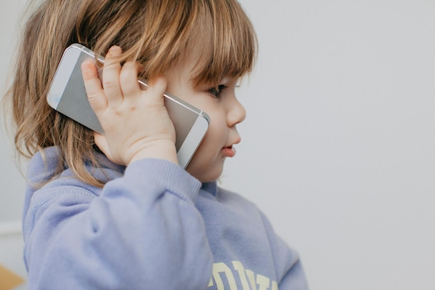 young woman using mobile phone against white background