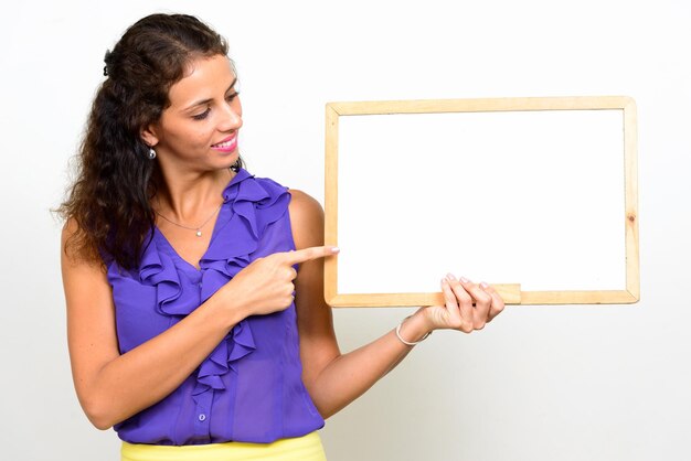 Young woman using mobile phone against white background