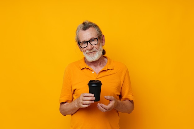 Young woman using mobile phone against yellow background