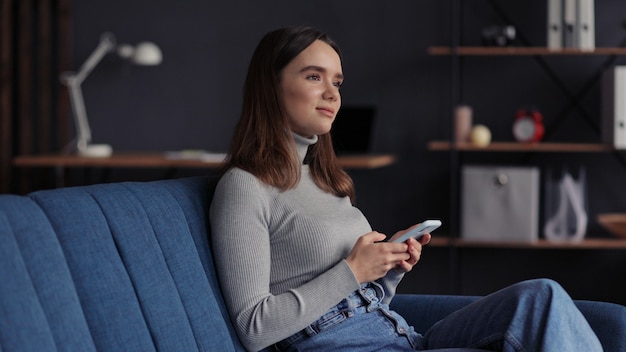 Young woman using mobile phone apps