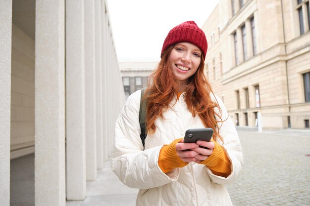 Young woman using mobile phone in city