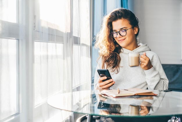 Young woman using mobile phone at home