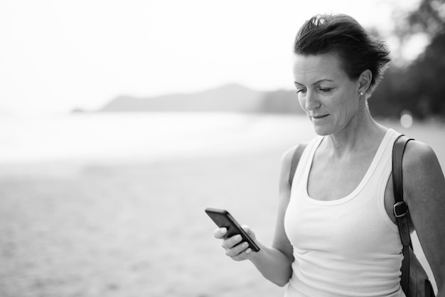 Young woman using mobile phone outdoors