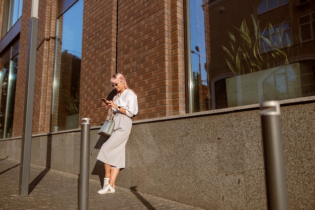 Young woman using mobile phone on the street