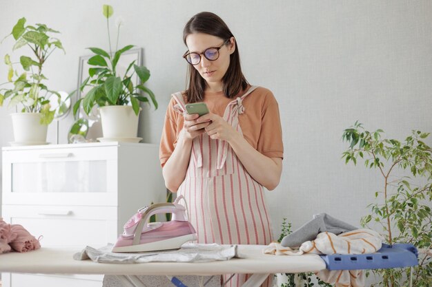 Young woman using mobile phone while sitting at home