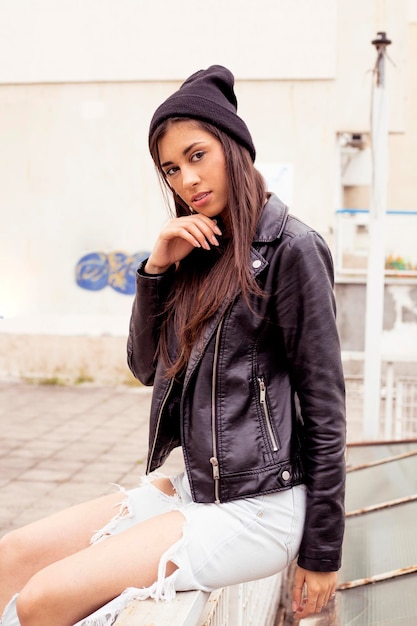 Young woman using mobile phone while sitting at home