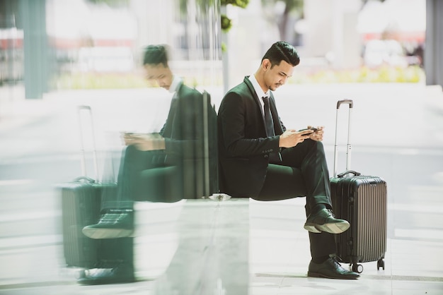 Young woman using mobile phone while sitting on seat