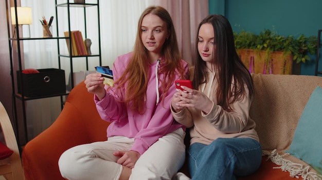 Young woman using mobile phone while sitting on sofa at home