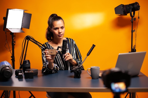 Young woman using mobile phone while sitting on table