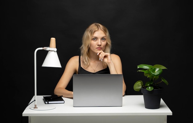 Young woman using mobile phone while sitting on table