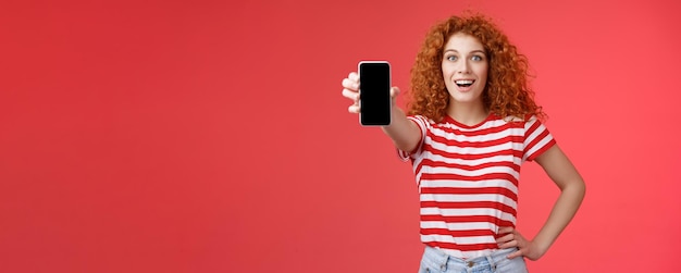 Photo young woman using mobile phone while standing against yellow background