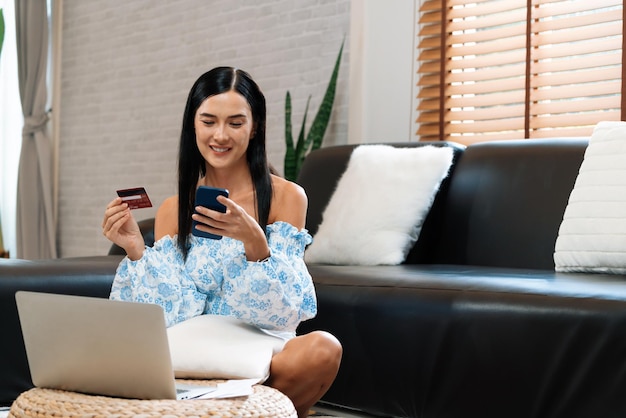 Young woman using online payment app via smartphone Blithe