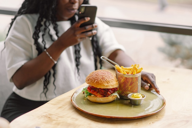 Young woman using phone in cafe