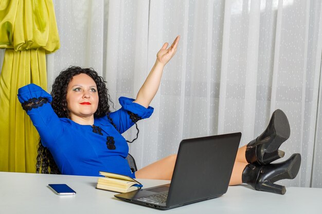 Young woman using phone while sitting on table