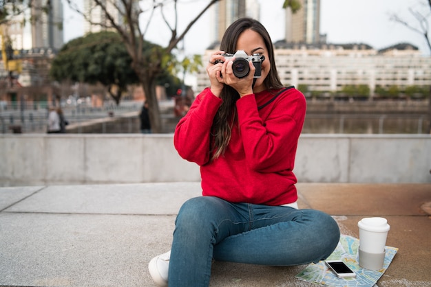 Young woman using a professional camera.