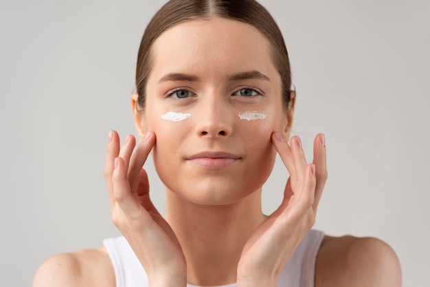 Young woman using a skin care cream