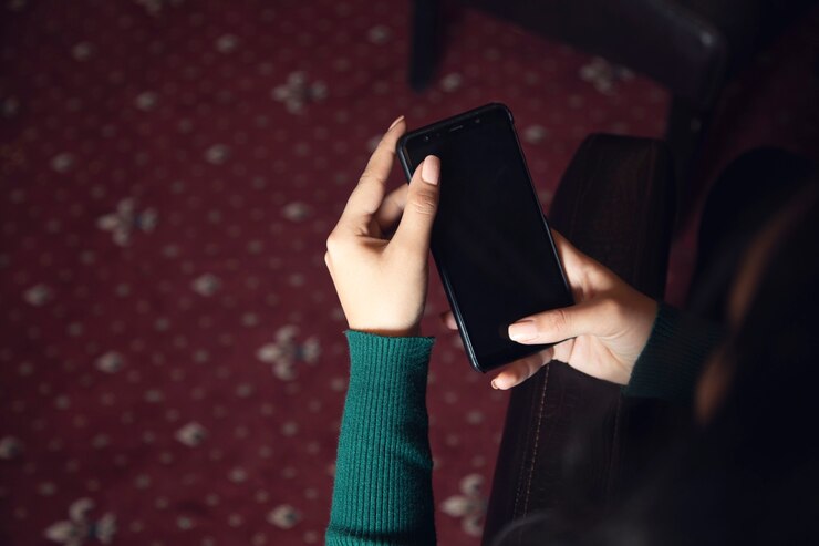 Young woman using smart phone in room