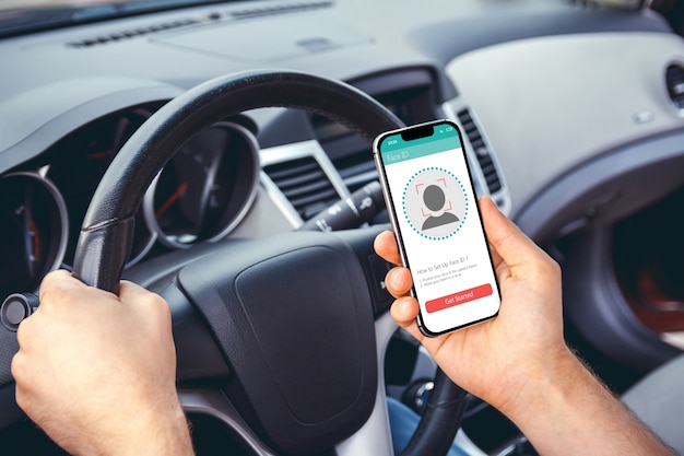 Young woman using a smartphone in the car