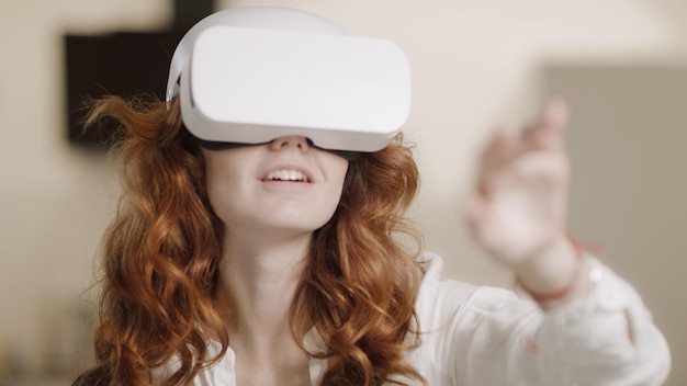Young woman using virtual glasses Female person moving arm in virtual glasses