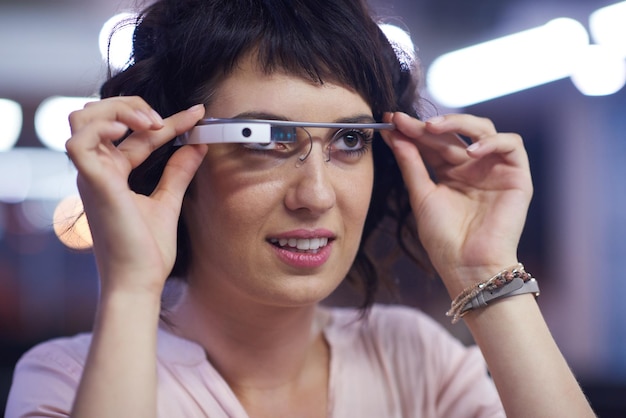 young woman using virtual reality gadget computer technology glasses