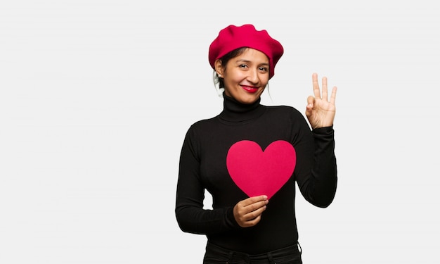 Young woman in valentines day cheerful and confident doing ok gesture