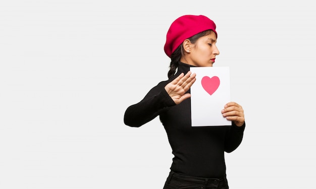 Young woman in valentines day putting hand in front