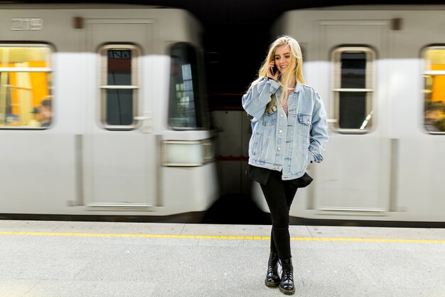 Young woman waiting train in underground