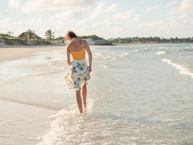 Young woman walking along the coast of the Atlantic Ocean