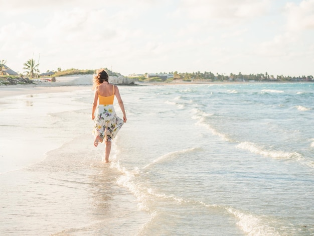 Young woman walking along the coast of the Atlantic Ocean