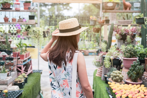 Young woman walking in the cactus garden