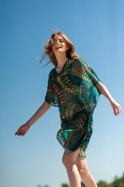 Young woman walking on the sand near the sea