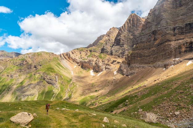 A young woman walking through the mountains with her son in the backpack in the Ripera valley Pyrenees