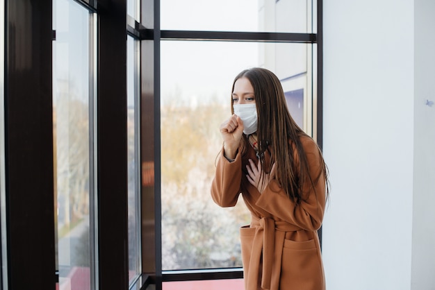 A young woman walks in a mask during the pandemic