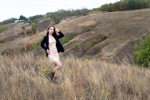 Young woman walks in nature among the mountains