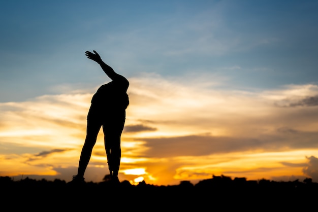 Young woman warming up outdoors at park