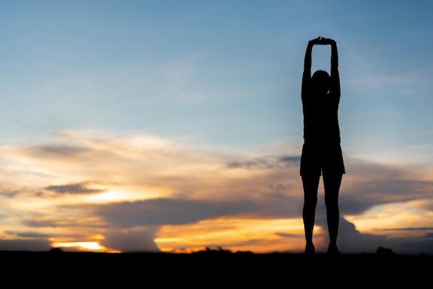 Young woman warming up outdoors at park