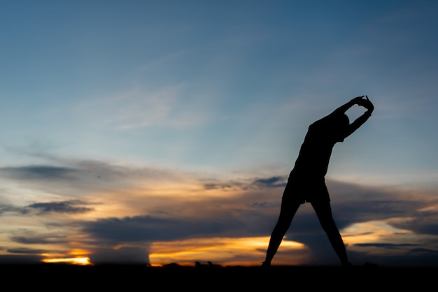 Young woman warming up outdoors at park