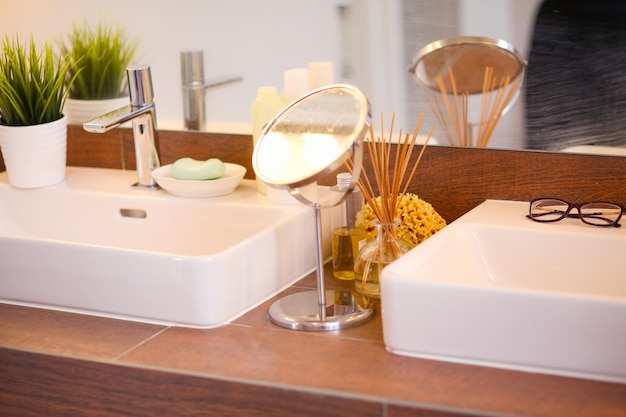 Young woman washing her face with clean water in bathroom