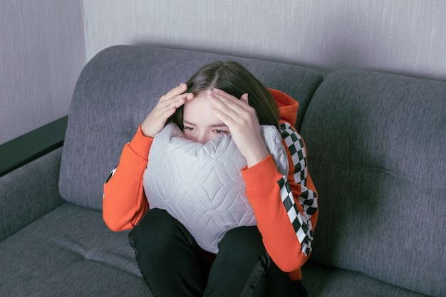 A young woman watches TV