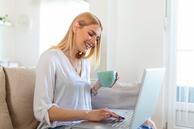 Young woman waving at laptop and talking to her friends via\
video call girl student talking by video conference call female\
teacher trainer tutoring by webcam online training ecoaching\
concept