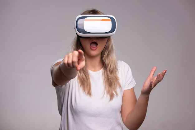 Young woman wear VR headset standing and watch movie