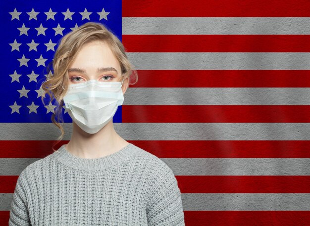 Young woman wearing a face mask with flag USA Flu epidemic and virus protection concept