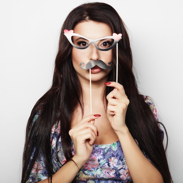 Young woman wearing fake mustaches Ready for party