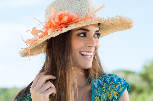 Young Woman Wearing Floral Straw Hat