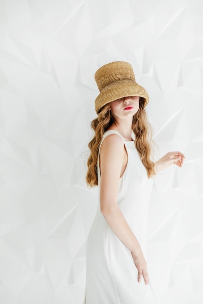 Young woman wearing a hat pulled over her eyes