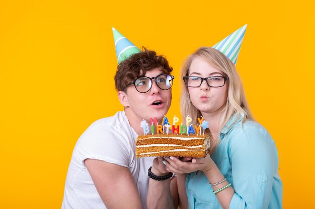 Young woman wearing mask against yellow background