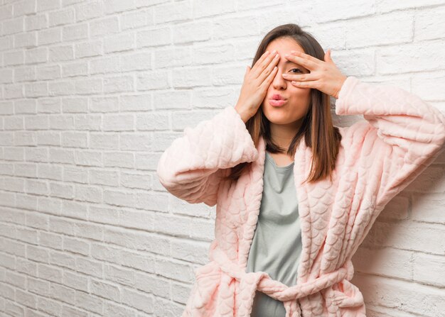 Young woman wearing pajama feels worried and scared