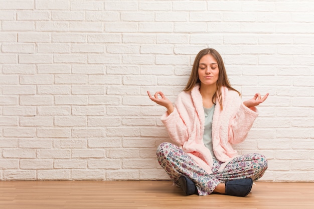 Young woman wearing pajama performing yoga