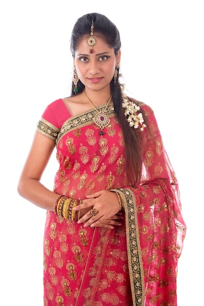 young woman wearing red sari standing against white background